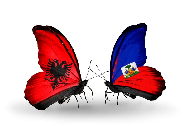 Butterflies with Albania and Haiti flags — Stock Photo, Image