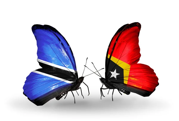 Fjärilar med botswana och east timor flaggor — Stockfoto