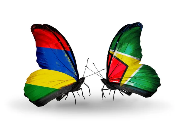 Vlinders met mauritius en guyana vlaggen — Stockfoto