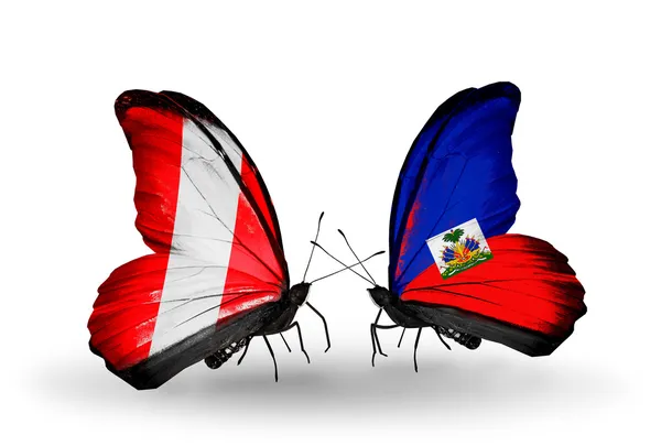 Butterflies with Peru and Haiti flags — Stock Photo, Image