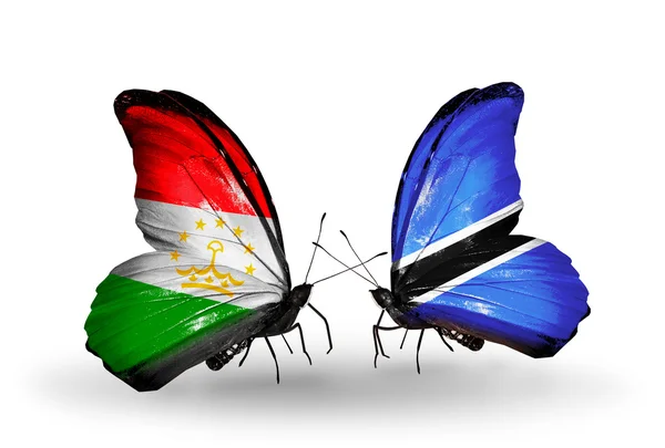 Borboletas com bandeiras do Tajiquistão e Botsuana — Fotografia de Stock
