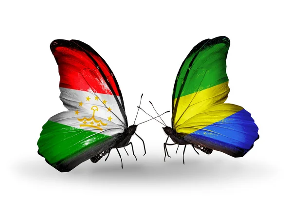 Butterflies with Tajikistan and Gabon flags — Stock Photo, Image