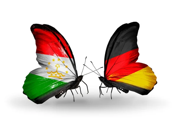 与塔吉克斯坦和德国国旗的蝴蝶 — 图库照片