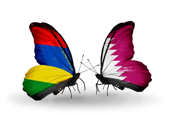 Butterflies with   Mauritius and  Qatar flags — Stock Photo, Image