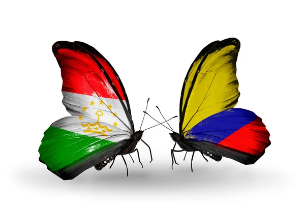 Butterflies with Tajikistan and Columbia flags — Stock Photo, Image