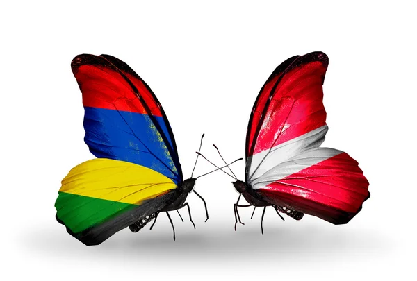 Butterflies with Mauritius and Latvia flags — Stock Photo, Image