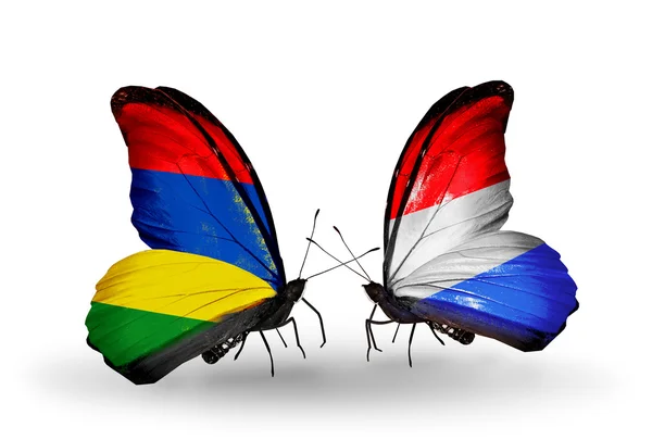 Butterflies with Mauritius and Luxembourg flags — Stock Photo, Image