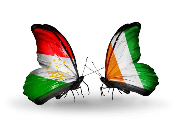 Borboletas com bandeiras do Tajiquistão e da Costa do Marfim — Fotografia de Stock