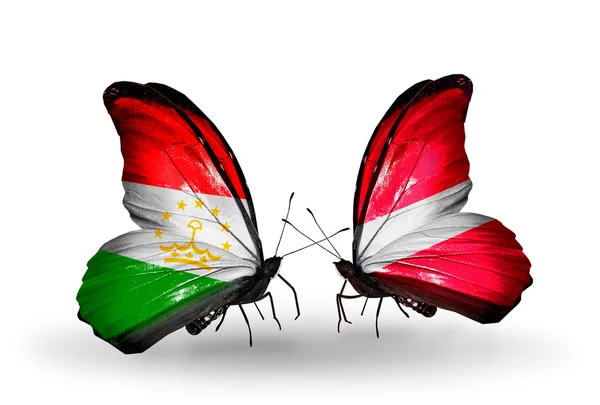 Butterflies with Tajikistan and Latvia flags — Stock Photo, Image