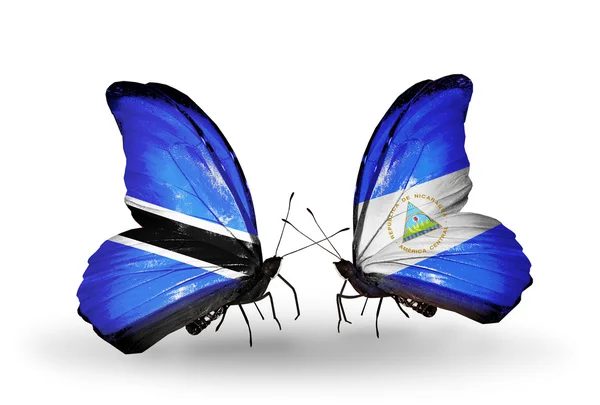 Butterflies with Botswana and Nicaragua flags — Stock Photo, Image