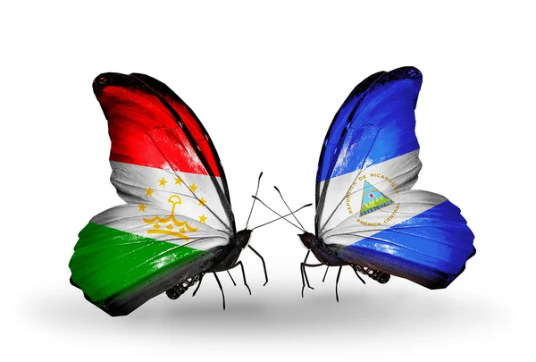 Mariposas con banderas de Tayikistán y Nicaragua — Foto de Stock
