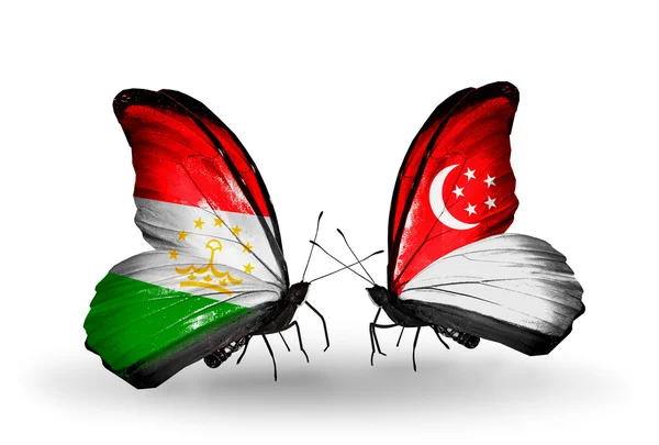 Butterflies with Tajikistan and Singapore flags — Stock Photo, Image