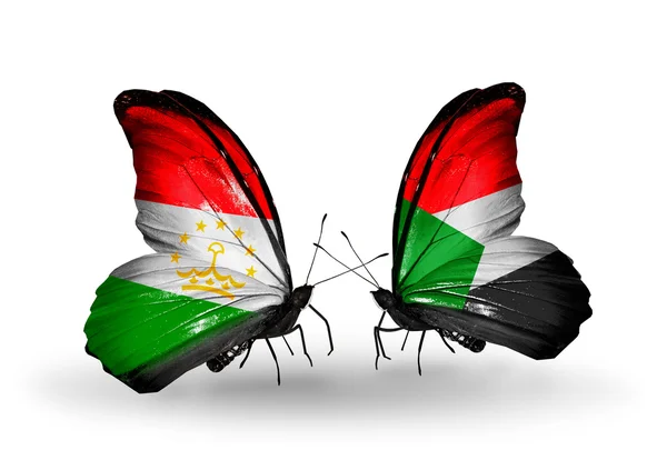 Butterflies with Tajikistan and Sudan flags — Stock Photo, Image