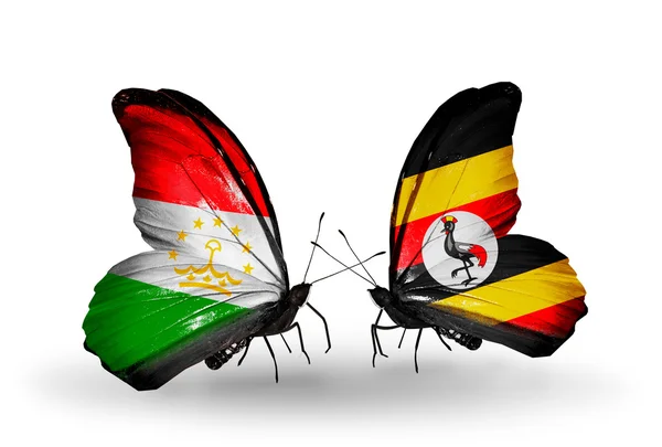 Butterflies with Tajikistan and Uganda flags — Stock Photo, Image