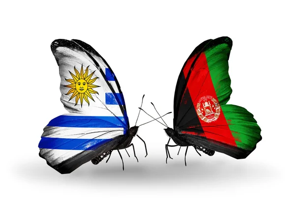 Pillangók, uruguay és Afganisztán zászlókkal — Stock Fotó