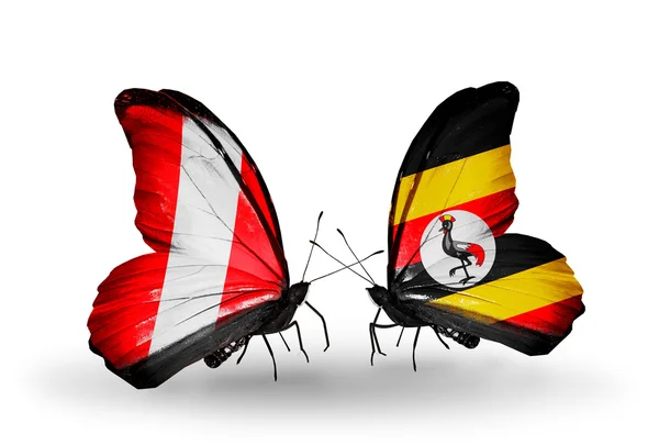 Vlinders met peru en uganda vlaggen — Stockfoto