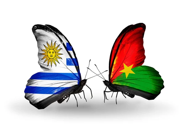 Fjärilar med uruguay och burkina faso flaggor — Stockfoto