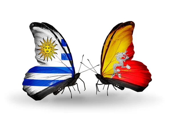 Butterflies with Uruguay and Bhutan flags — Stock Photo, Image