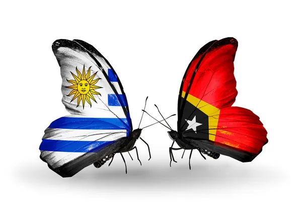 Farfalle con bandiere Uruguay e Timor Est — Foto Stock