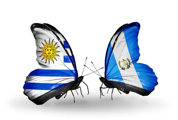 Farfalle con bandiere Uruguay e Guatemala — Foto Stock