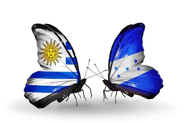 Farfalle con bandiere Uruguay e Honduras — Foto Stock