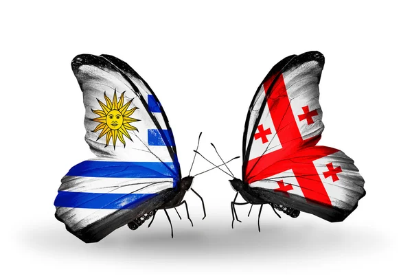 Butterflies with Uruguay and Georgia flags — Stock Photo, Image