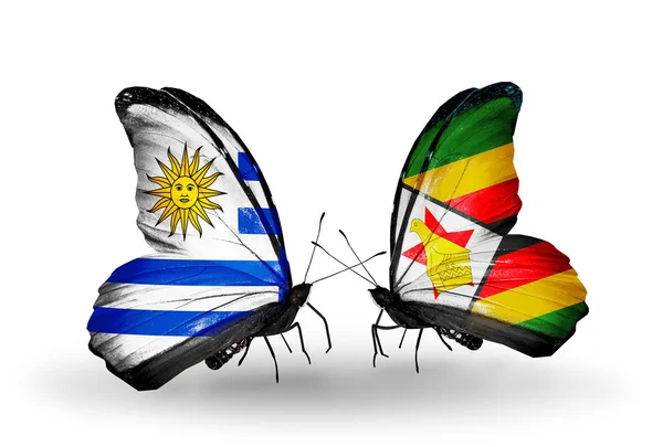 Borboletas com bandeiras do Uruguai e do Zimbabué — Fotografia de Stock