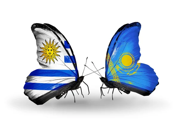 Butterflies with Uruguay and Kazakhstan flags — Stock Photo, Image