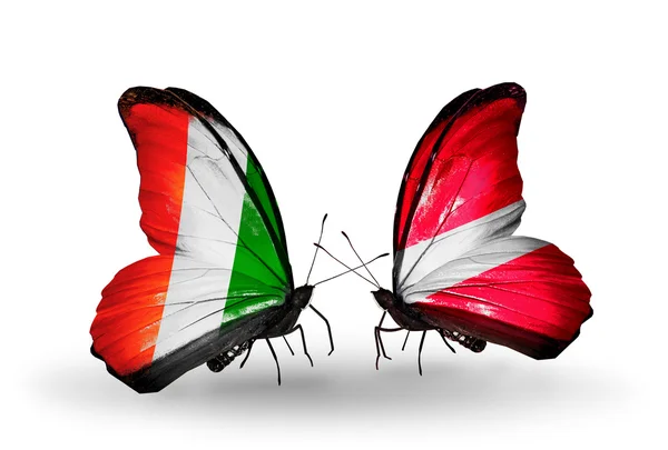 Butterflies with  Cote Divoire and Latvia flags — Stock Photo, Image