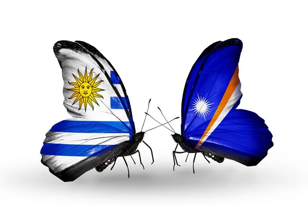 Butterflies with Uruguay and Marshall islands flags — Stock Photo, Image