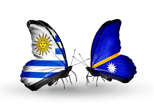 Butterflies with Uruguay and Nauru flags — Stock Photo, Image
