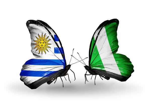 Butterflies with Uruguay and Nigeria flags — Stock Photo, Image