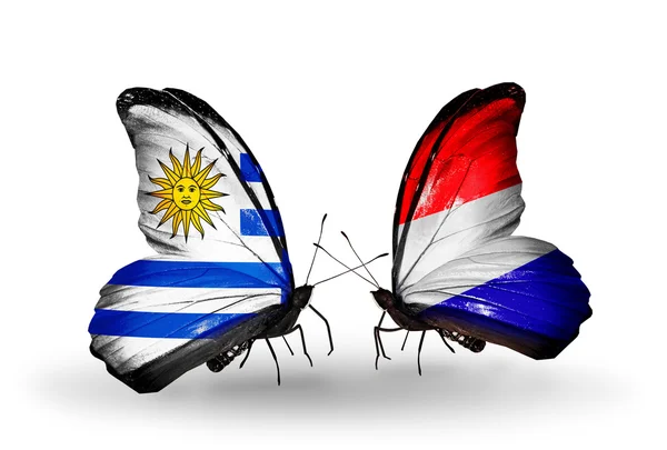 Borboletas com bandeiras do Uruguai e Holanda — Fotografia de Stock