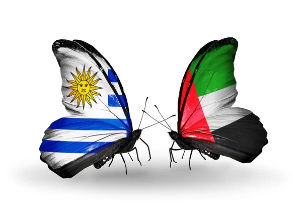 Butterflies with Uruguay and UAE flags — Stock Photo, Image