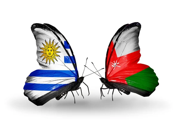 Butterflies with Uruguay and Oman flags — Stock Photo, Image