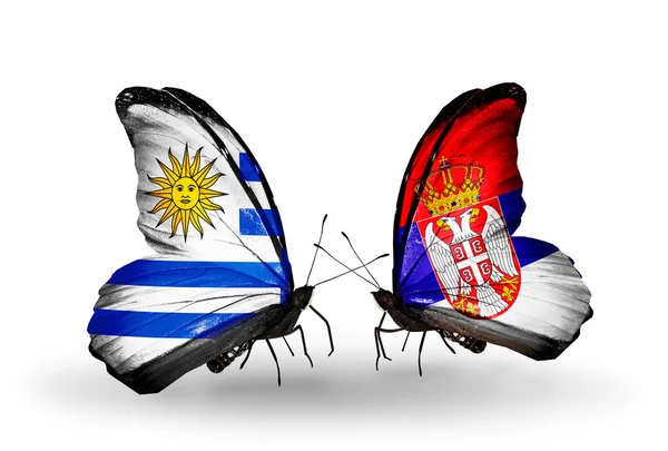 Butterflies with Uruguay and Serbia flags — Stock Photo, Image