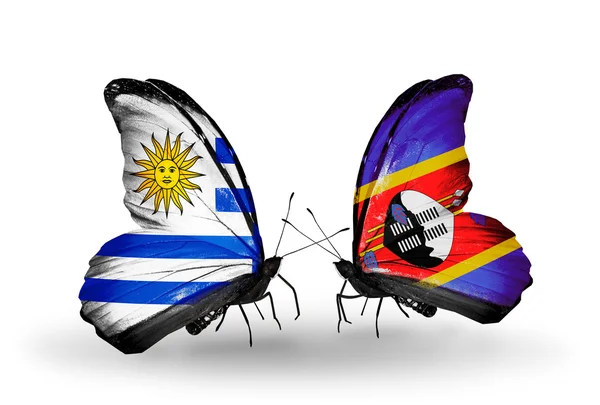 Butterflies with Uruguay and Swaziland flags — Stock Photo, Image