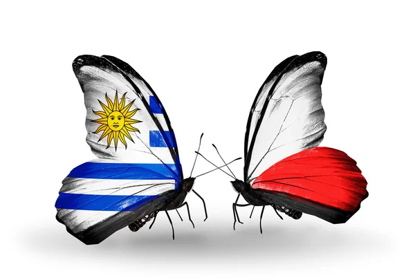 Butterflies with Uruguay and Poland flags — Stock Photo, Image