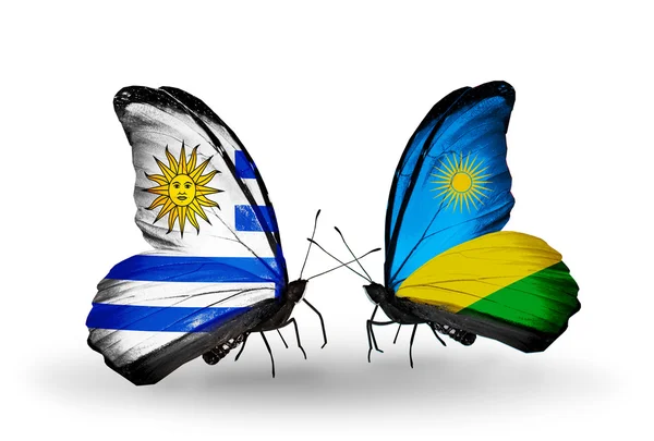 Butterflies with Uruguay and Rwanda flags — Stock Photo, Image