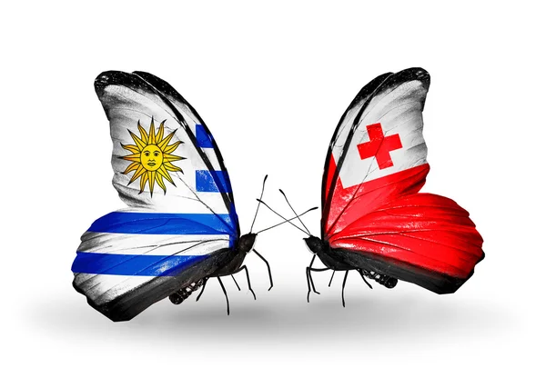 Sommerfugler med Uruguay og Tonga-flagg – stockfoto