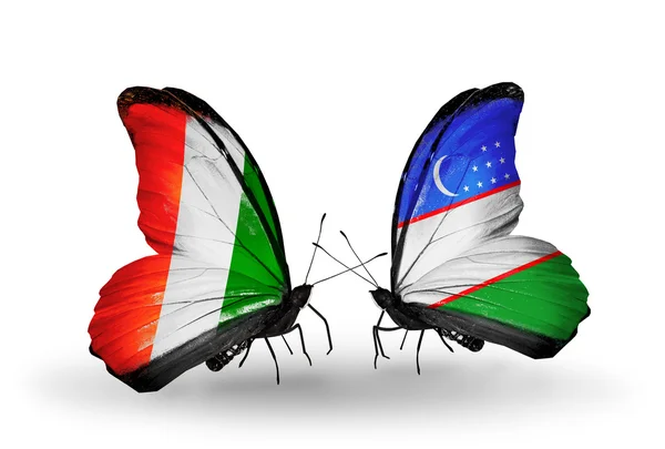 Schmetterlinge mit Cote-Divoire-Fahnen und usbekischen Flaggen — Stockfoto