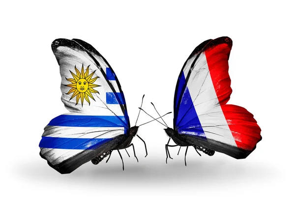 Schmetterlinge mit uruguayischen und französischen Flaggen — Stockfoto