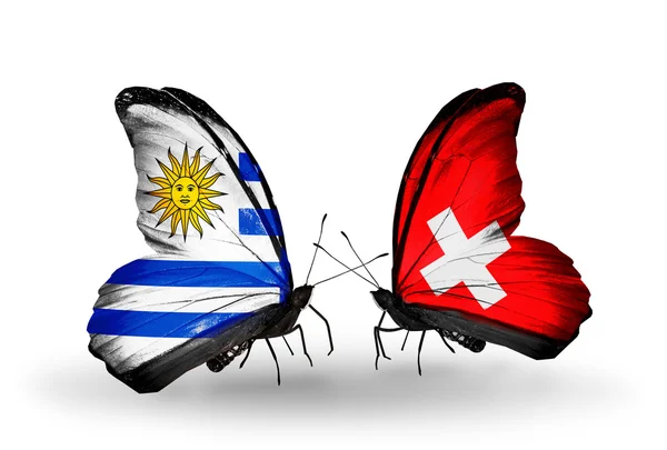 Butterflies with Uruguay and Switzerland flags — Stock Photo, Image