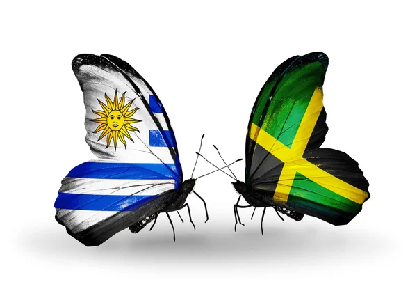Borboletas com bandeiras do Uruguai e Jamaica — Fotografia de Stock