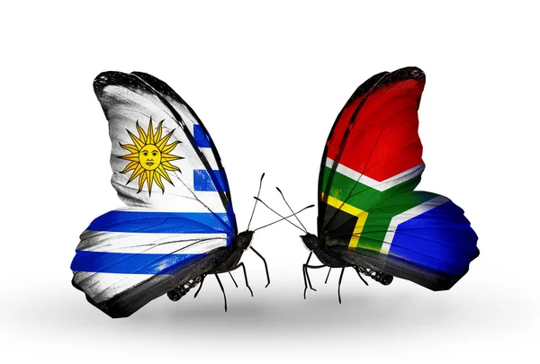 Vlinders met vlaggen uruguay en Zuid-Afrika — Stockfoto