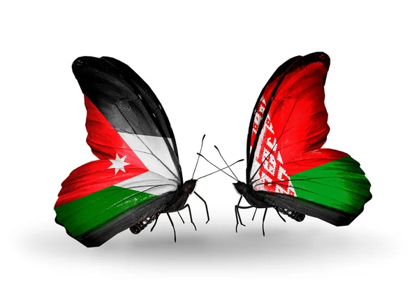 Motýli s Jordánskem a Bělorusko vlajky na křídlech — Stock fotografie