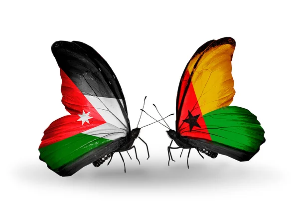 Fjärilar med Jordanien och guinea bissau flaggor — Stockfoto