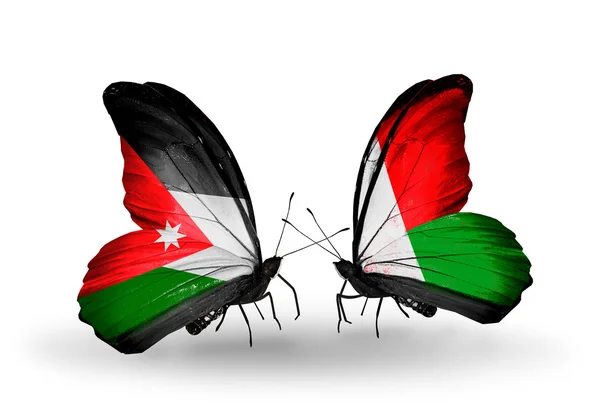 Farfalle con bandiere Giordania e Madagascar — Foto Stock