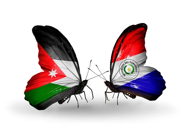 Duas borboletas com bandeiras da Jordânia e Paraguai — Fotografia de Stock