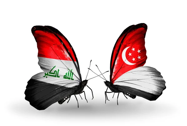 イラクとシンガポールの国旗と 2 匹の蝶 — ストック写真